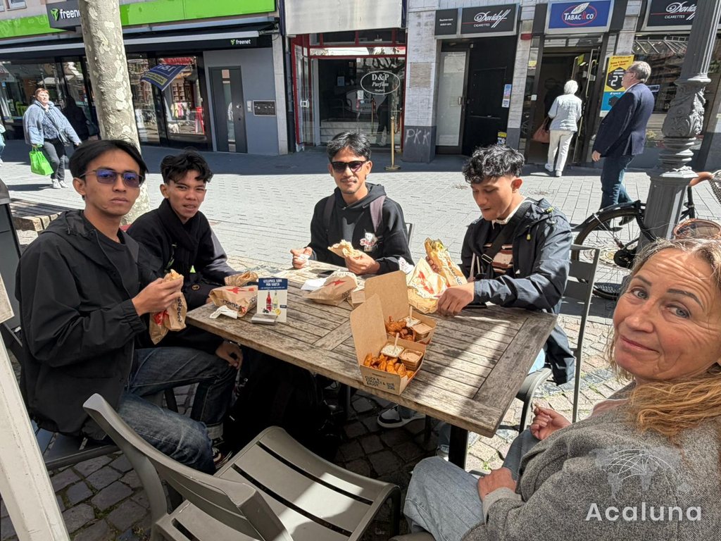 Apprentices from Indonesia eating together in a town centre